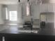 Bright kitchen features white cabinets, stainless steel appliances, and a stylish island with modern lighting at 183 Waverly Rd, Walterboro, SC 29488