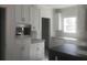 Well-equipped kitchen featuring granite countertops, stainless steel microwave and white cabinetry at 183 Waverly Rd, Walterboro, SC 29488