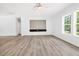 Bright living room with light wood-look floors, built-in shelving, and a ceiling fan at 183 Waverly Rd, Walterboro, SC 29488