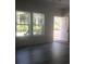 Naturally lit living room with sleek flooring and access to an outdoor deck at 183 Waverly Rd, Walterboro, SC 29488