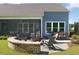 Backyard with a cozy outdoor seating area featuring a stone fire pit at 2094 Cousteau Ct, Johns Island, SC 29455