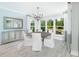 Bright dining area features a modern chandelier, a large mirror, and large picture windows with backyard views at 2094 Cousteau Ct, Johns Island, SC 29455