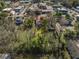 An aerial view features a property with mature trees, a green lawn, and surrounding neighborhood amenities at 222 E Main St, Moncks Corner, SC 29461