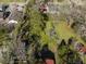 Aerial view highlighting a spacious backyard with mature trees and a fire pit, perfect for outdoor entertaining at 222 E Main St, Moncks Corner, SC 29461