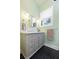Bathroom featuring stylish vanity, mirror, and black tile flooring at 222 E Main St, Moncks Corner, SC 29461