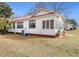 Side view of cozy cottage home with a red roof, surrounded by a beautiful yard at 222 E Main St, Moncks Corner, SC 29461