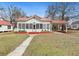 Charming home featuring a metal roof, covered porch, and well-maintained lawn at 222 E Main St, Moncks Corner, SC 29461