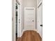Hallway with hardwood floors, storage and white doors at 222 E Main St, Moncks Corner, SC 29461