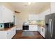 Bright kitchen with stainless steel appliances, including a modern refrigerator and oven at 222 E Main St, Moncks Corner, SC 29461