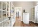 Organized pantry with ample shelving, access to kitchen, and mini fridge provides convenient storage and functionality at 222 E Main St, Moncks Corner, SC 29461