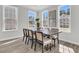Bright dining room features modern wood table, chair set, and plentiful natural light from large windows at 232 O'Malley Dr, Summerville, SC 29483
