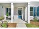 Inviting covered front porch with neutral decor, charming front door, and well-maintained landscaping at 232 O'Malley Dr, Summerville, SC 29483