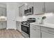 Modern kitchen features stainless steel oven and microwave, subway tile backsplash, and gray cabinets at 232 O'Malley Dr, Summerville, SC 29483