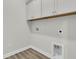 Spacious laundry area features modern wood flooring with water hookups, electric outlets, and bright paint at 232 O'Malley Dr, Summerville, SC 29483