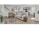 Open-concept living area with a fireplace, couch, leading to a modern kitchen and staircase at 232 O'Malley Dr, Summerville, SC 29483