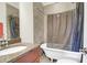 Bathroom featuring a clawfoot tub, granite vanity top, and neutral tile at 234 Rutledge Ave # D, Charleston, SC 29403