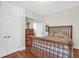 Bedroom featuring a bed with a wood frame, dresser and an open door to another room at 234 Rutledge Ave # D, Charleston, SC 29403