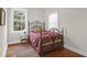 Cozy bedroom featuring a metal bed frame, hardwood floors, and natural light at 234 Rutledge Ave # D, Charleston, SC 29403