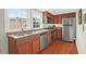 Well-lit kitchen featuring stainless steel appliances and beautiful wood floors at 234 Rutledge Ave # D, Charleston, SC 29403