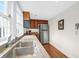 Bright kitchen with granite countertops, stainless steel appliances, and wooden cabinets at 234 Rutledge Ave # D, Charleston, SC 29403
