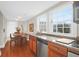 Open-concept kitchen and dining area featuring granite countertops and natural light at 234 Rutledge Ave # D, Charleston, SC 29403