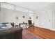 Well-lit living room features wood floors, a brown leather sofa, and a decorative rug at 234 Rutledge Ave # D, Charleston, SC 29403