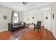 Inviting living room featuring a tufted sofa, area rug, and hardwood floors at 234 Rutledge Ave # D, Charleston, SC 29403
