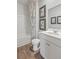 Well-lit bathroom features a vanity with chrome faucet and a tub with shower at 243 Watersglen Dr, Summerville, SC 29486