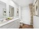 This bathroom features a double vanity with white countertops and sinks, wood-look flooring and a shower at 243 Watersglen Dr, Summerville, SC 29486