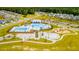Aerial view of a community center showcasing pools, splash pad, playground and open green space at 254 Watersglen Dr, Summerville, SC 29486