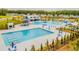 Aerial view of a community pool area with a slide, pools and plenty of lounge seating at 254 Watersglen Dr, Summerville, SC 29486