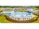 Aerial view of a resort-style community pool with cabanas and ample seating surrounded by green space at 254 Watersglen Dr, Summerville, SC 29486