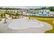 Aerial view of a community splash pad with picnic tables and the community pool in the background at 254 Watersglen Dr, Summerville, SC 29486