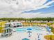 Aerial shot of the community pool, featuring a slide, lounge chairs, cabanas, and surrounding neighborhood homes at 276 Watersglen Dr, Summerville, SC 29486