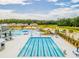 A long rectangular pool and an outdoor recreational area featuring a slide, lounge chairs, and cabanas at 276 Watersglen Dr, Summerville, SC 29486