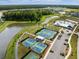 Breathtaking aerial view of the community amenities featuring tennis courts, a pool, clubhouse, and a serene pond at 332 Clearpath Dr, Summerville, SC 29486