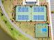 Aerial view of tennis courts, pickleball court, basketball court and green space with a backdrop of trees at 332 Clearpath Dr, Summerville, SC 29486