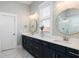 Modern bathroom with dual sinks, sleek cabinetry, stylish mirrors, and a glass-enclosed shower at 332 Clearpath Dr, Summerville, SC 29486