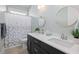 Bathroom with a double sink vanity, round mirrors, and a shower with a patterned curtain at 332 Clearpath Dr, Summerville, SC 29486