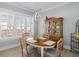 Bright dining room with a wooden table, decorative hutch, and natural light at 332 Clearpath Dr, Summerville, SC 29486
