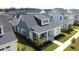 Charming exterior elevation of a home with a front porch, in a community with neat landscaping and street view at 332 Clearpath Dr, Summerville, SC 29486