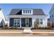 Charming home featuring a welcoming front porch, white columns, dark blue siding, and a well-manicured yard at 332 Clearpath Dr, Summerville, SC 29486