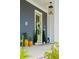 Inviting front porch with stylish decor and a vibrant green door at 332 Clearpath Dr, Summerville, SC 29486