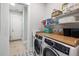 Bright laundry room features washer, dryer, and shelving at 332 Clearpath Dr, Summerville, SC 29486