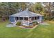 Sprawling home with a spacious yard and cozy front porch in a peaceful, wooded setting at 3348 River Landing Rd, Johns Island, SC 29455