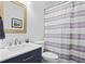 Bathroom featuring a sink with a granite countertop, a framed mirror, and a shower with a striped curtain at 3348 River Landing Rd, Johns Island, SC 29455