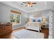 Calming bedroom with a tray ceiling, wood floors, large window, and a cool color palette at 3348 River Landing Rd, Johns Island, SC 29455