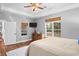 Comfortable bedroom with neutral colors, wooden dresser, wood floors, and bright windows at 3348 River Landing Rd, Johns Island, SC 29455