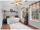 Bright bedroom with a ceiling fan, two windows, and a daybed with decorative pillows and throw at 3348 River Landing Rd, Johns Island, SC 29455