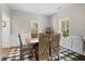 Dining room with rustic wooden table, wicker chairs, and multiple windows at 3348 River Landing Rd, Johns Island, SC 29455